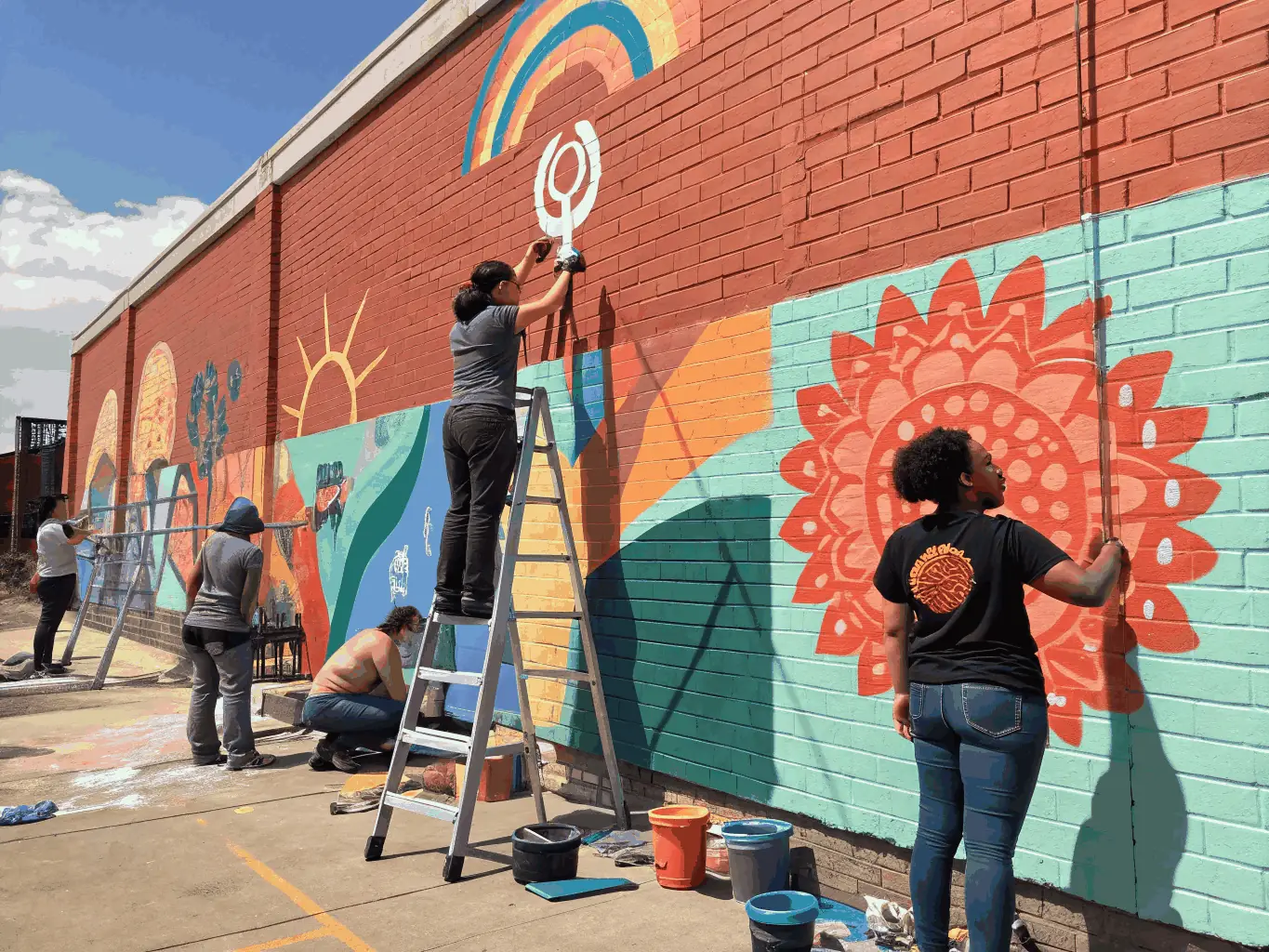 A vibrant image of artists creating a mural in a public space, reflecting ARSIS's commitment to artistic creation and cultural expression.